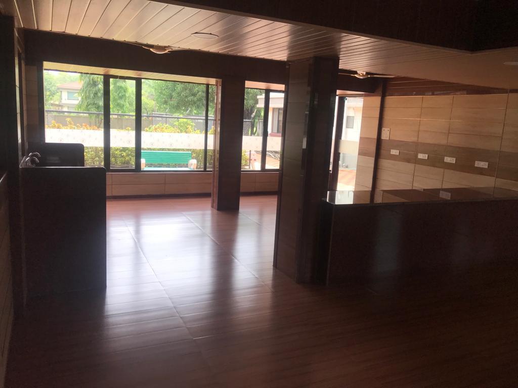 Auditorium hall with full-height windows overlooking the garden