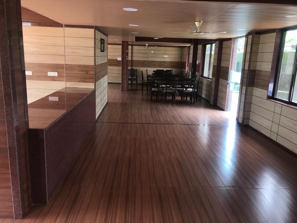 Auditorium seating area with tables and chairs at the far end