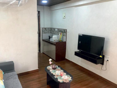 Suite living room with wall-mounted TV, pantry and center table